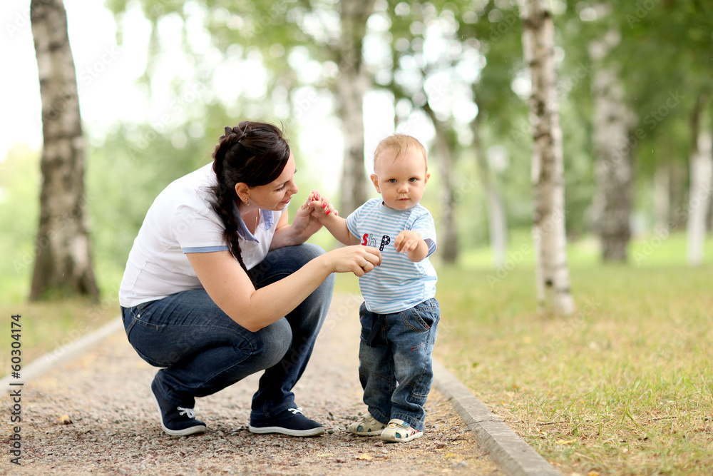 Fototapeta premium happy young mother playing with baby in the park