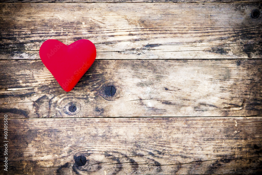 Wood background with red heart and nothing else.