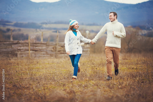 Young couple walking together while enjoying a day in park