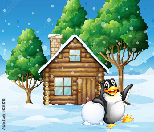 A penguin in front of the wooden house