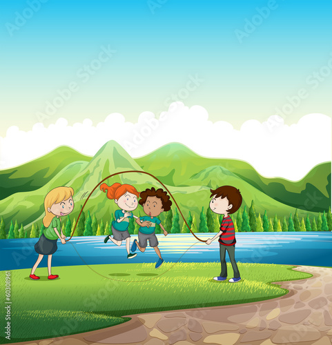 Kids playing skipping rope at the riverbank