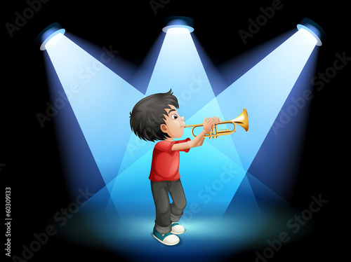 A young boy with a trumpet at the stage