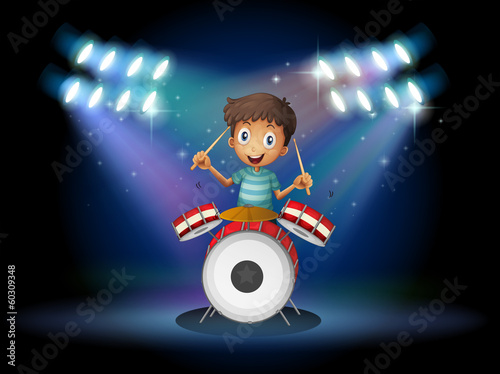 A young drummer at the center of the stage
