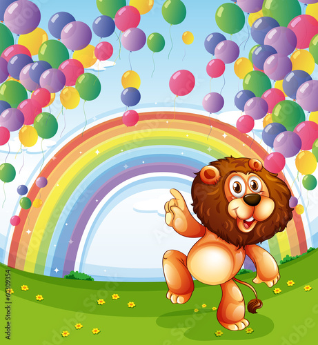 A lion below the floating balloons with a rainbow