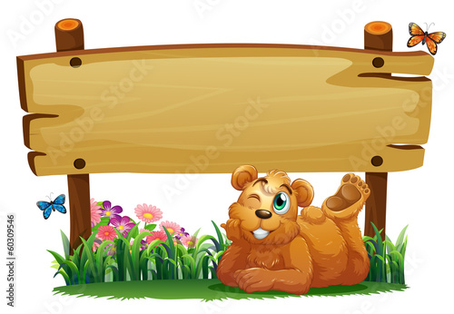 A cute bear under the empty wooden signboard