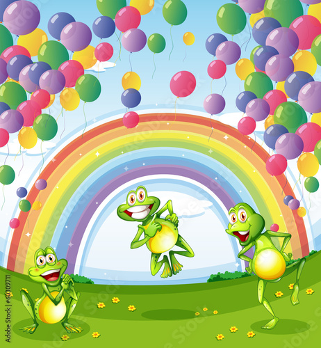 Three frogs under the floating balloons near the rainbow
