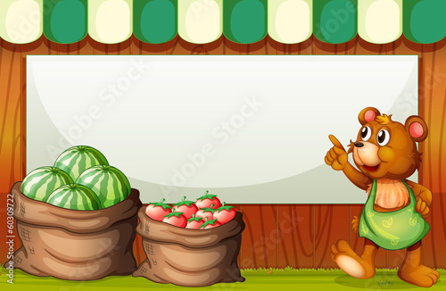 A bear pointing the empty signboard at the market