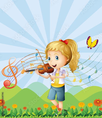 A girl at the hilltop playing with her violin