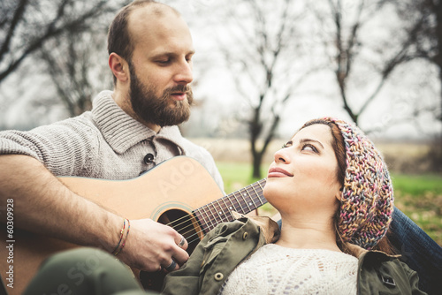 couple in love playing serenade with guitar