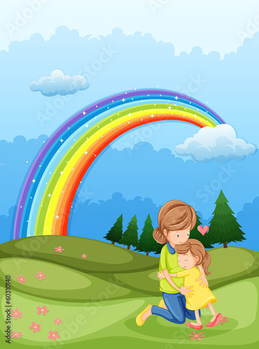 A mother and a child hugging near the rainbow