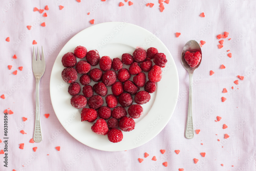 Raspberries in a plate in a shape of heart Raspberries in a plate in a shape of heart
