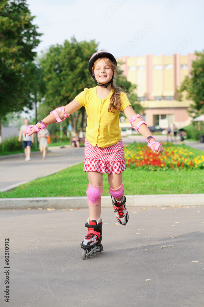 Girl in a helmet, elbow pads and knee pads roller-skating Stock Photo |  Adobe Stock