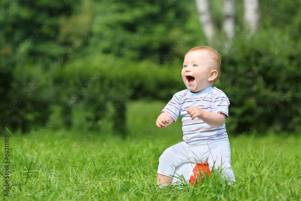 Smiling little boy sitting on an inflatable ball Smiling little boy sitting on an inflatable ball