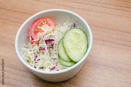 Tomato, cucumber and cabbage salad in a white bowl