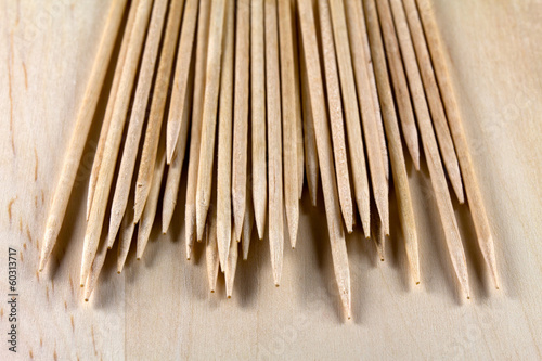The pile of toothpicks on a wooden surface