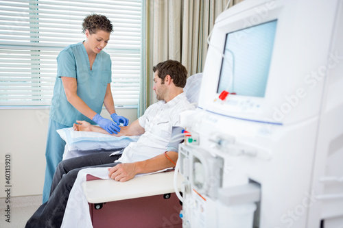 Nurse Injecting Patient For Renal Dialysis Treatment