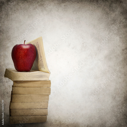 Grunge background with stack of books and red apple