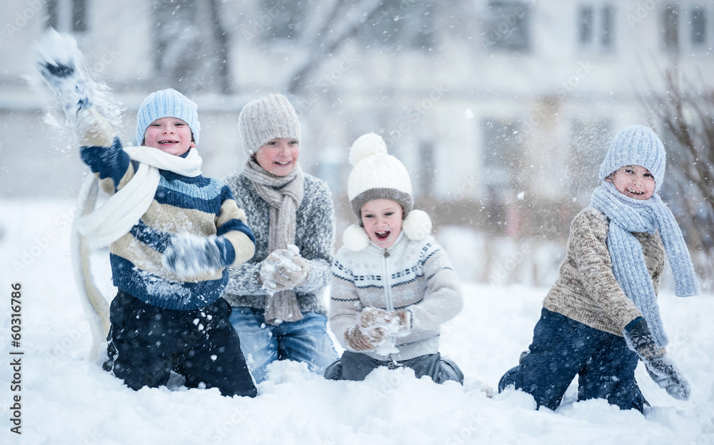 Children playing in the snow on a winter day