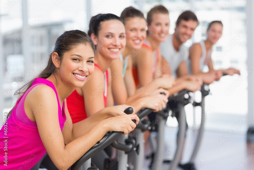 Fit young people working out at spinning class Fit young people working out at spinning class