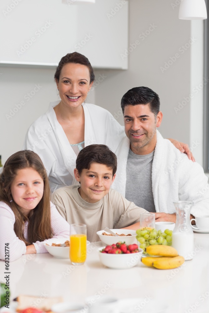 Happy kids enjoying breakfast with parents