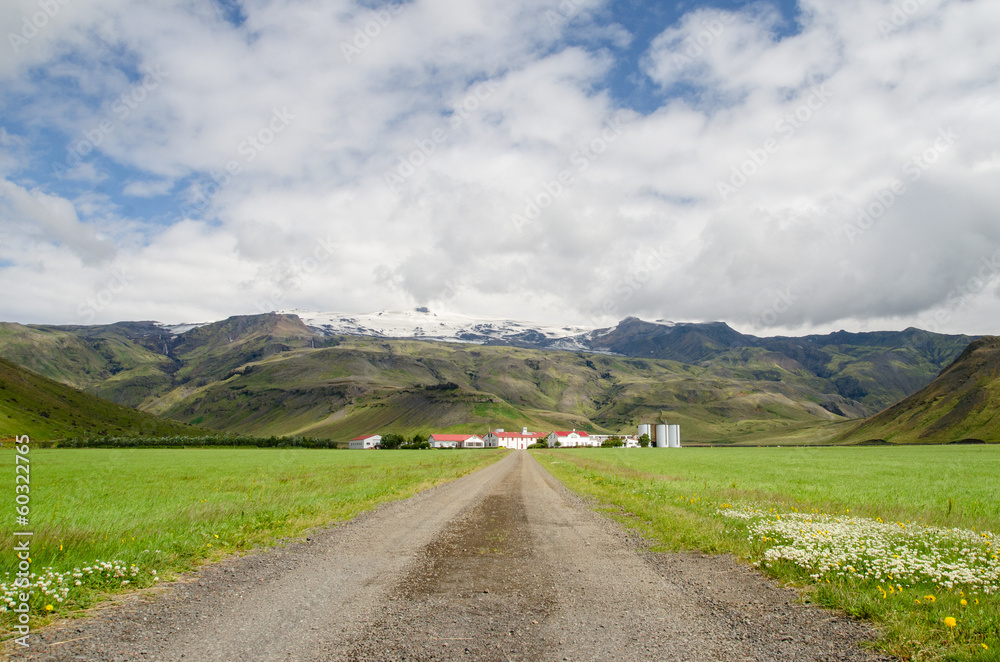 Icelandic farm dwarfed by the mountains