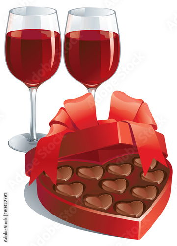 two wineglasses and heart shaped box of chocolates candy