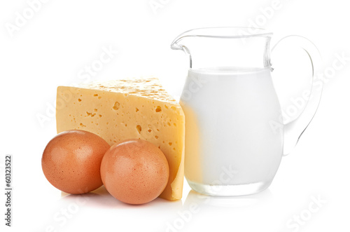 Big piece of cheese, glass jug with milk