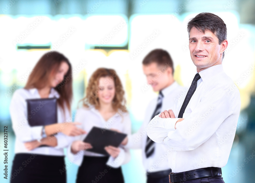 Successful business man standing with his staff Successful business man standing with his staff