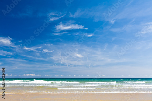 Sand beach, calm sea and blue sky, copy space