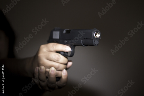 Hand holding gun preparing to fire