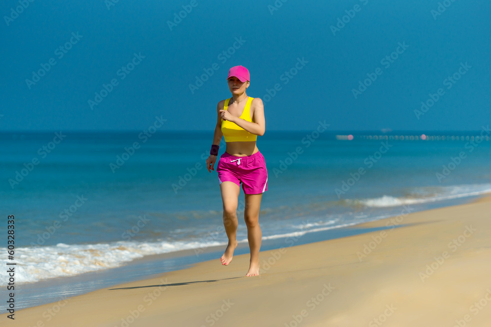 Healthy Woman running on beach. Beautiful fitness adult girl