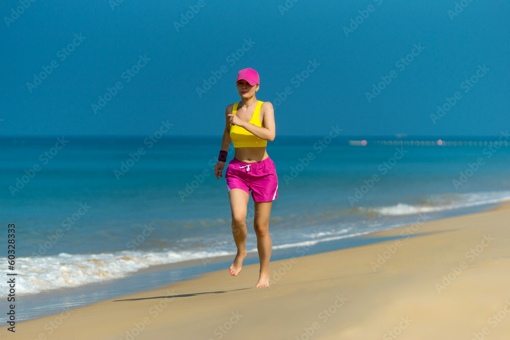 Healthy Woman running on beach. Beautiful fitness adult girl Healthy Woman running on beach. Beautiful fitness adult girl