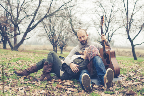 couple in love playing serenade with guitar