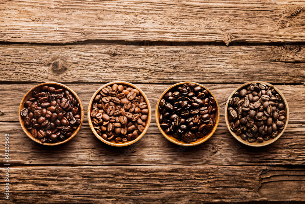 Assorted coffee beans on a driftwood background - obrazy, fototapety, plakaty 