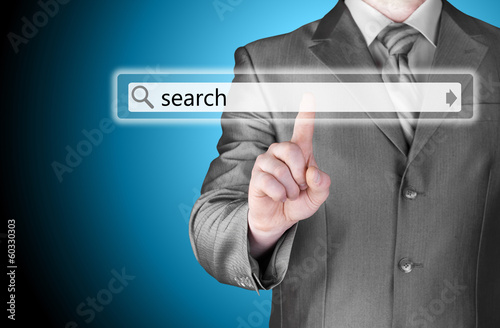 Businessman pushing virtual search bar