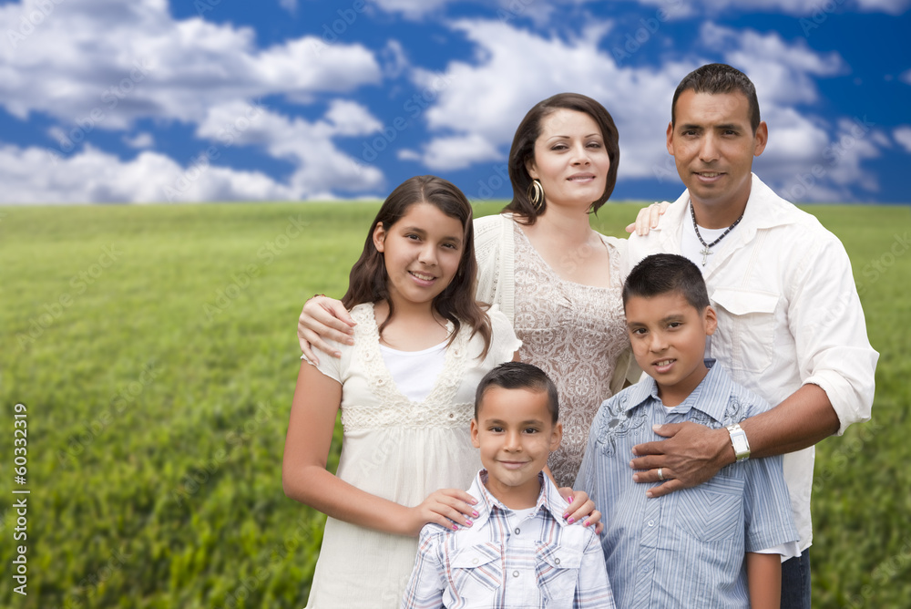 Hispanic Family Portrait Standing in Grass Field Hispanic Family Portrait Standing in Grass Field