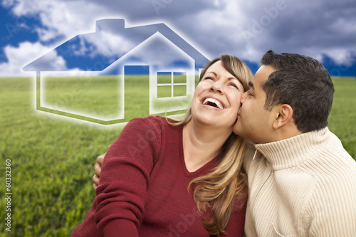 Happy Couple Sitting in Grass Field with Ghosted House Behind