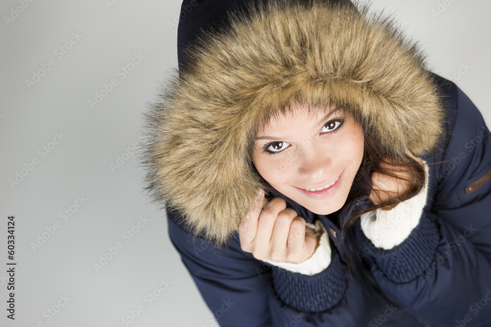 Cute girl in winter clothes looking up and lovely smiling. Cute girl in winter clothes looking up and lovely smiling.
