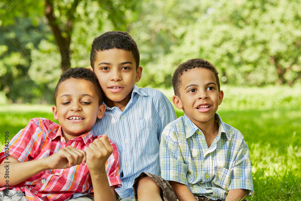 Portrait of three smiling boys-brothers who sit together Portrait of three smiling boys-brothers who sit together