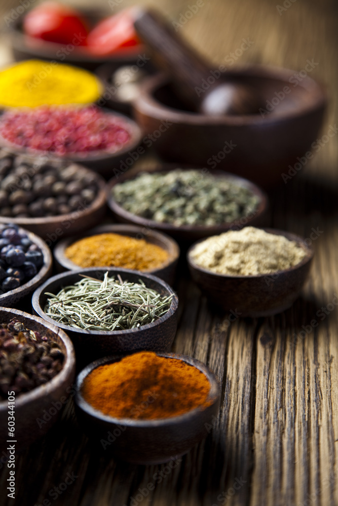 Assortment of spices in wooden bowl background 