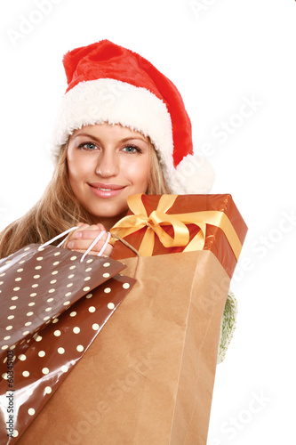 Young woman with Santa hat holding shopping bags