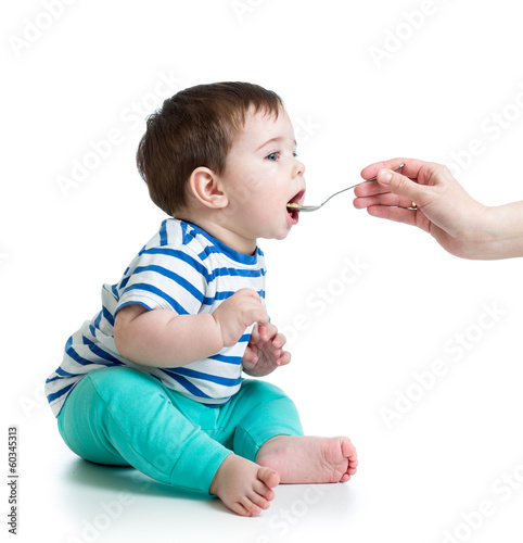 Mother's hand feeding baby ...