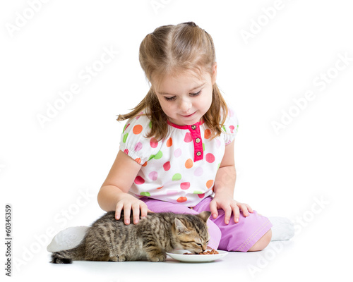 little girl feeding cat kitten