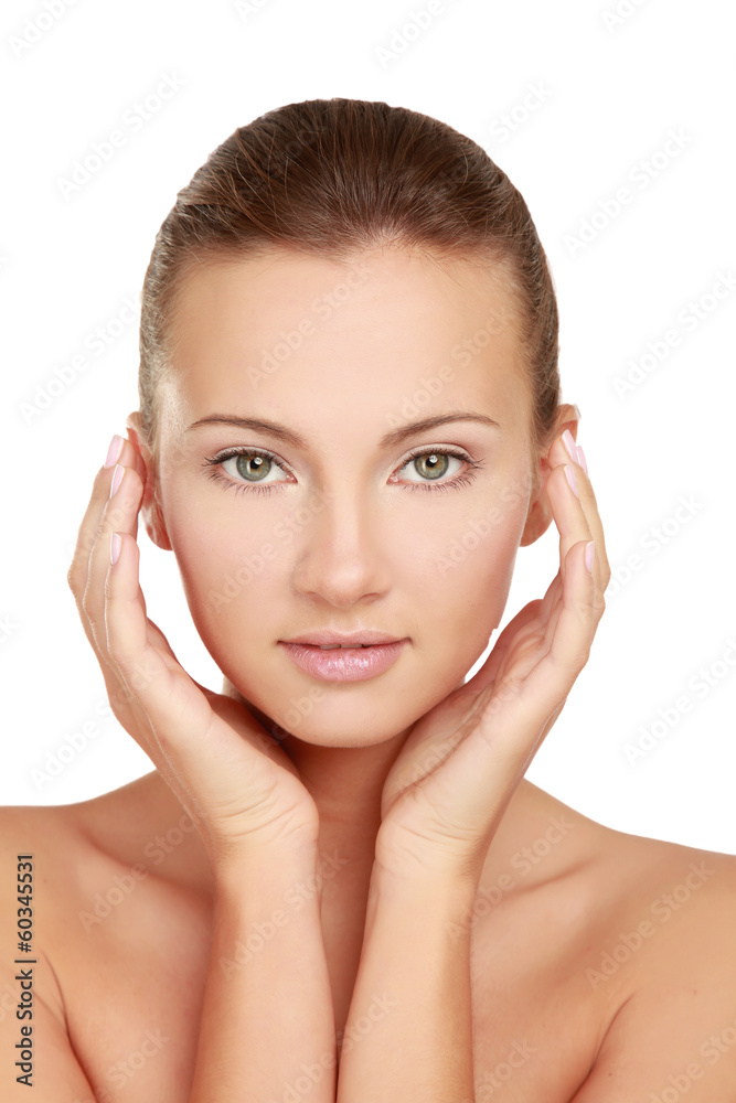A beautiful young woman touching her face