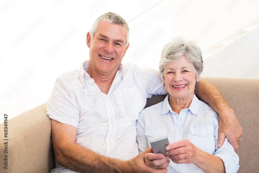 Smiling couple using mobile phone Smiling couple using mobile phone
