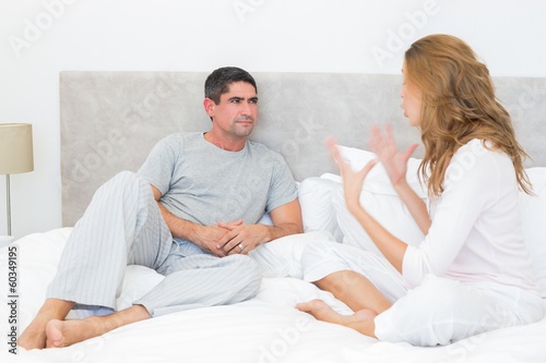 Couple arguing in bed