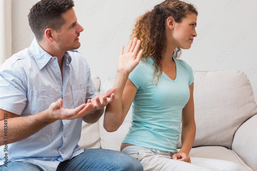 Couple arguing in living room Couple arguing in living room