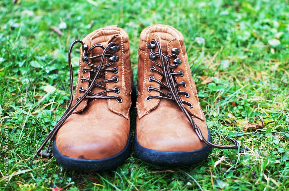 Brown leather boots in the grass Brown leather boots in the grass