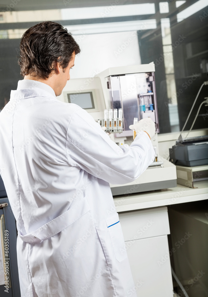 Scientist Analyzing Urine Samples In Laboratory Scientist Analyzing Urine Samples In Laboratory