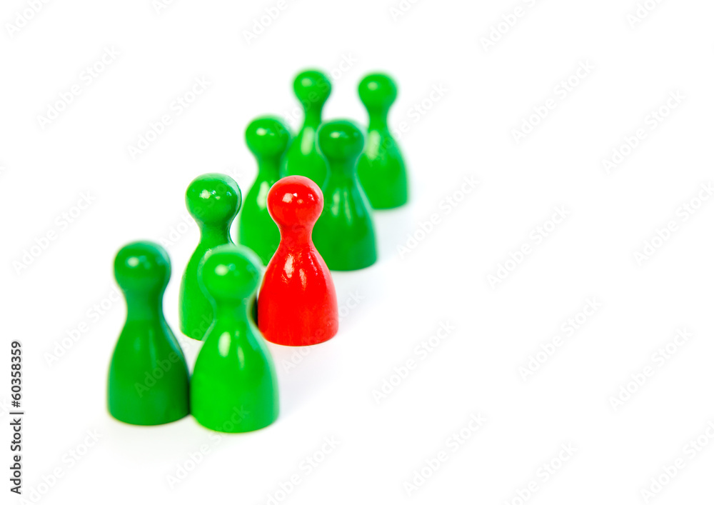 Red pawn in a line-up of green pawns Red pawn in a line-up of green pawns